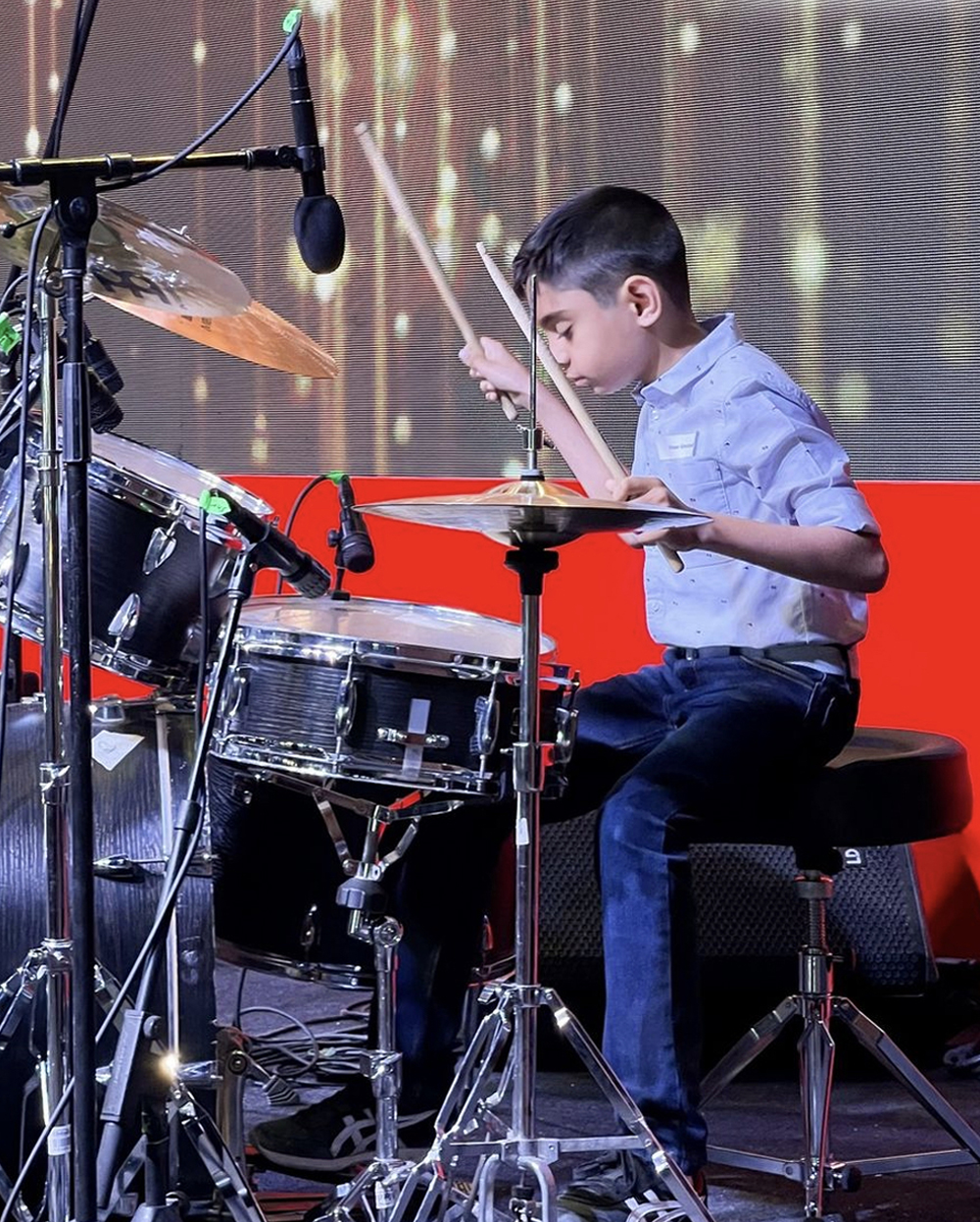 Viaan Ghorpade performing drums at a concert in Dubai